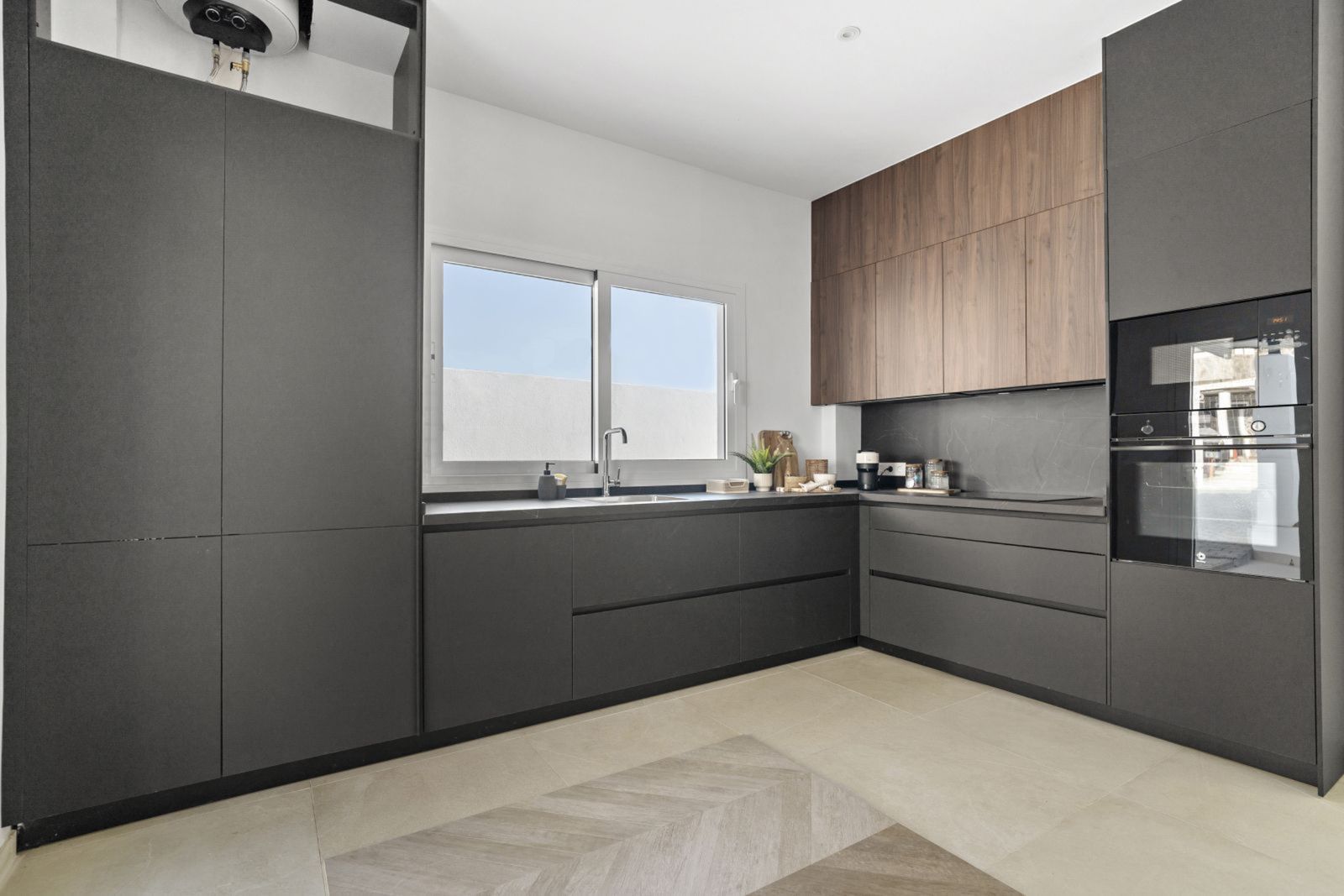 Nowoczesna szara kuchnia z drewnianymi akcentami i eleganckimi liniami